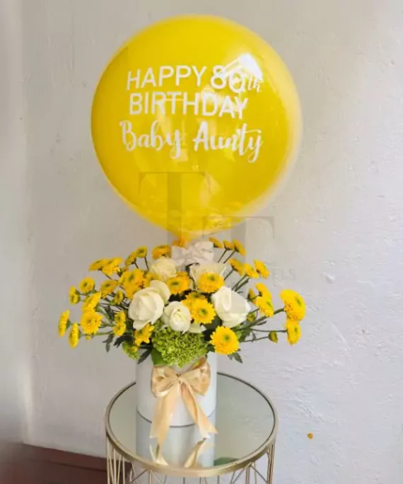 yellow balloons and flower bundle